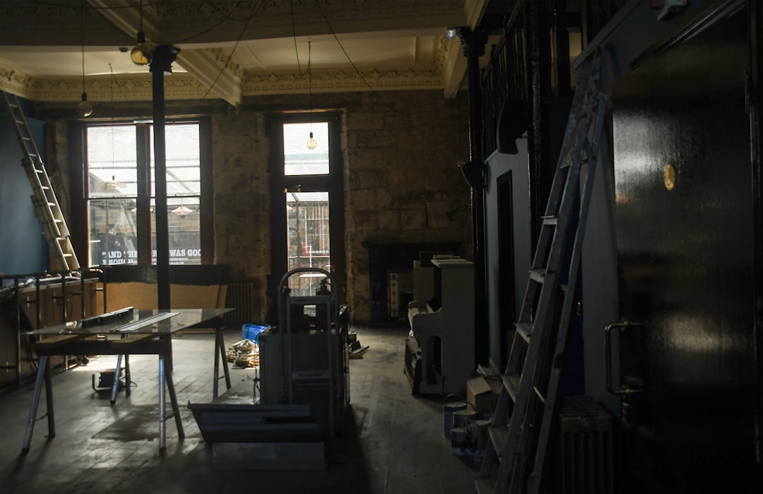 Large industrial fans and dehumidifiers placed on the floor of a room with stripped walls, actively drying the space after water damage.